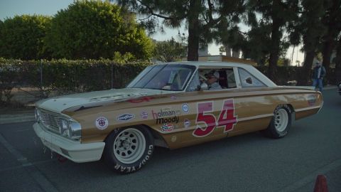 1993 Ford Taurus - A vintage race car, likely a 1963 Ford Galaxie, is parked outdoors with a driver inside.
