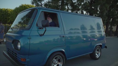 1993 Ford Taurus - A blue panel van is parked outdoors with a driver visible inside.
