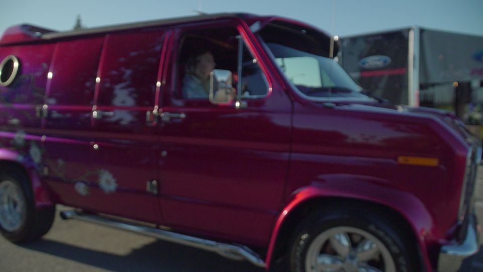 Purple van with floral graphics and chrome trim, side view