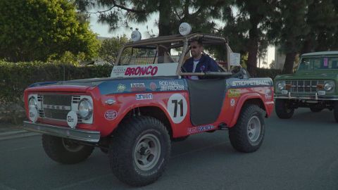 1993 Ford Taurus - A vintage Ford Bronco, modified for racing, is parked next to another Bronco.