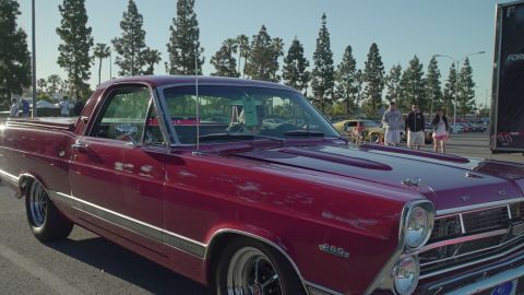 1993 Ford Taurus - A maroon 1967 Ford Ranchero is parked at an outdoor car show with other vehicles visible.