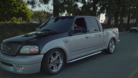 1993 Ford Taurus - This two-tone pickup truck features a silver body with a black roof and hood, complemented by chrome wheels.