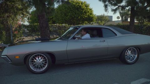 1993 Ford Taurus - Side view of a 1970 Ford Torino GT coupe driving on a paved surface.