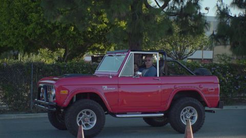 1993 Ford Taurus - This red Ford Bronco, likely from the mid-1970s, is seen from a three-quarter front view.