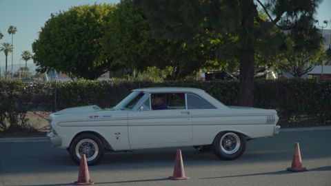 1993 Ford Taurus - A classic white Ford Falcon Sprint is seen from the side, with traffic cones marking a path.