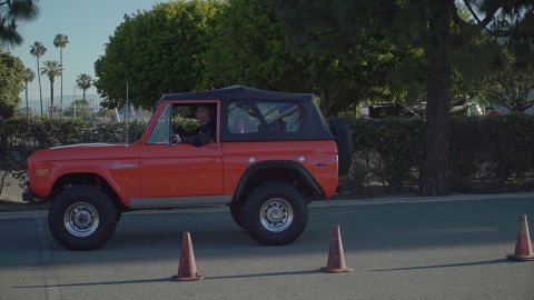 1993 Ford Taurus - First-gen Ford Bronco, likely from the mid-1970s, navigates a course marked by traffic cones.