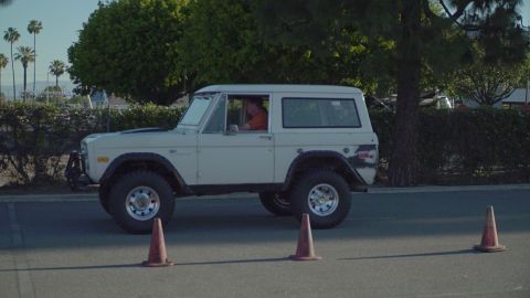 1993 Ford Taurus - A white 1978 Ford Bronco is seen from the side, navigating around traffic cones.