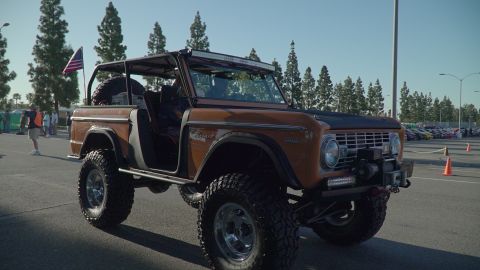 1993 Ford Taurus - A modified first-generation Ford Bronco is parked outdoors under a clear sky.