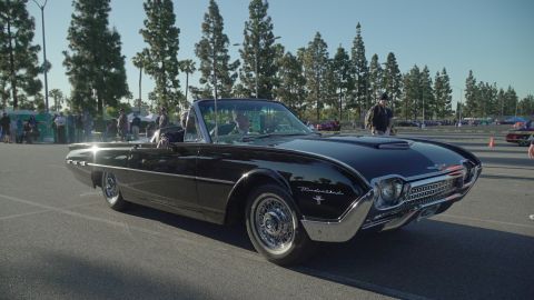 1993 Ford Taurus - Classic black 1961 Ford Thunderbird convertible parked outdoors.