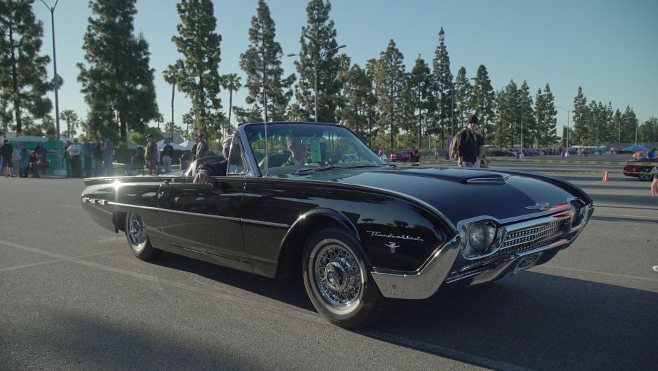 Black 1961 Ford Thunderbird convertible with chrome trim and wire wheels