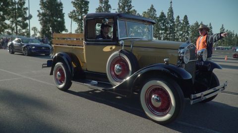 1993 Ford Taurus - A vintage pickup truck is seen at a car show, with a modern car in the background.