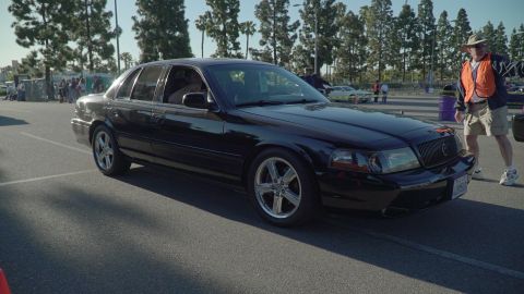 1993 Ford Taurus - A black Mercury Grand Marquis is shown from the front-three-quarter view at an outdoor event.