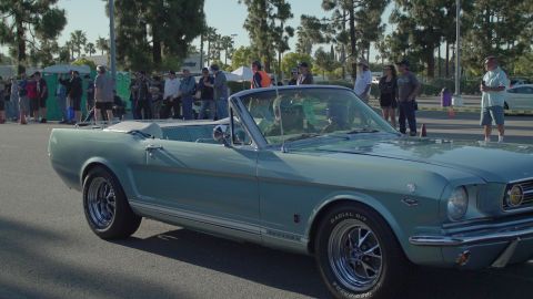 1993 Ford Taurus - A classic light blue convertible Mustang is seen at an outdoor car show event.