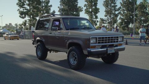 1993 Ford Taurus - A lifted Ford Bronco II is shown from the front-right angle at an outdoor event.