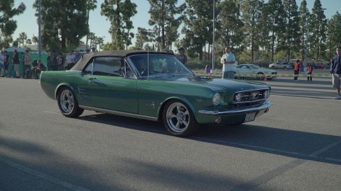 1993 Ford Taurus - A green 1965 Ford Mustang convertible is seen at a car show.
