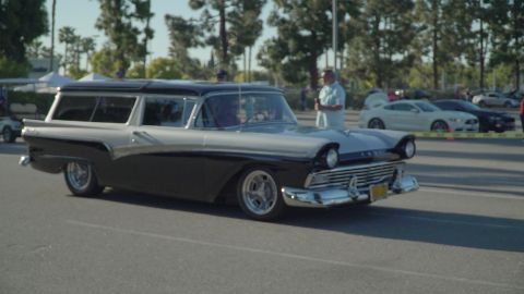 1993 Ford Taurus - Classic two-tone 1957 Ford station wagon at a car show with other vehicles in the background.