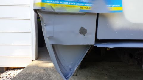 1976 Ford Ranchero - A close-up view of the lower rear corner of a vehicle, showing a section that has been repaired and primed. The vehicle appears to be a pic…