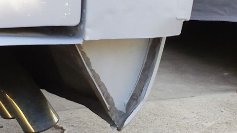 1976 Ford Ranchero - A close-up view of the rear bumper area of a vehicle, showing a triangular section of the bumper that appears to be undergoing repair or mo…