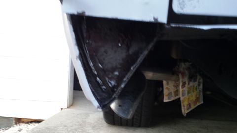 1976 Ford Ranchero - The rear bumper and suspension system of a vehicle are visible in this close-up shot.