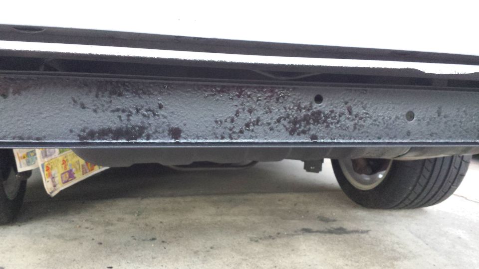 Dark blue rear bumper with visible scuffs and scratches