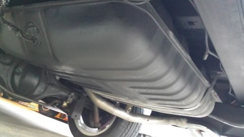 1976 Ford Ranchero - Underside view of a vehicle's fuel tank and exhaust components, with the rear axle visible.