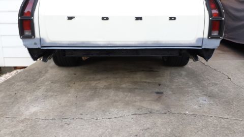 1976 Ford Ranchero - Rear view of a white Ford Ranchero, displaying the "FORD" lettering and its bumper.