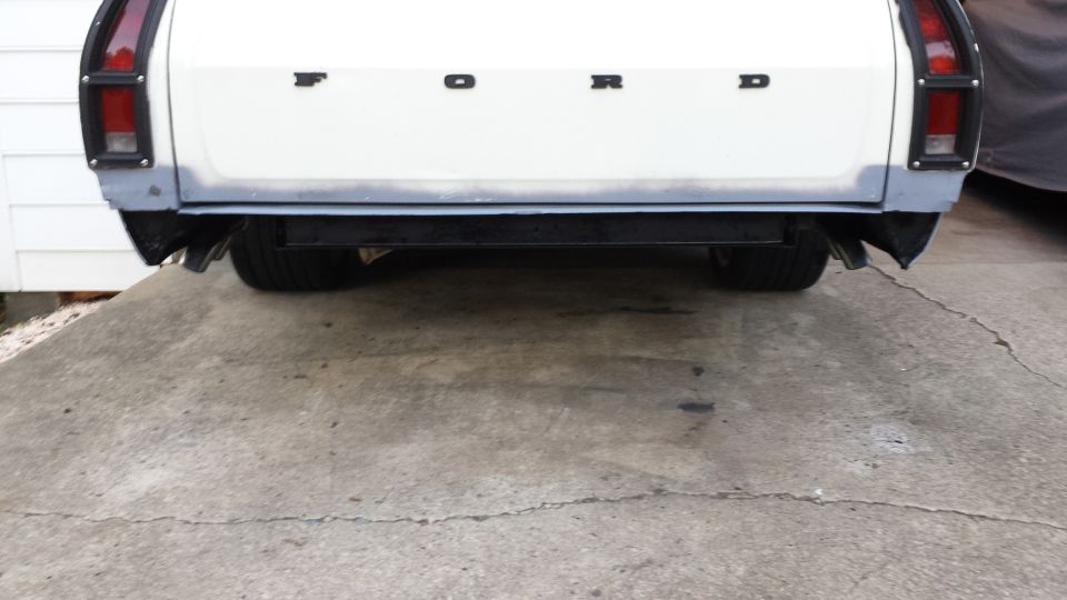 White Ford Ranchero rear view, showing taillights, "FORD" lettering, and bumper