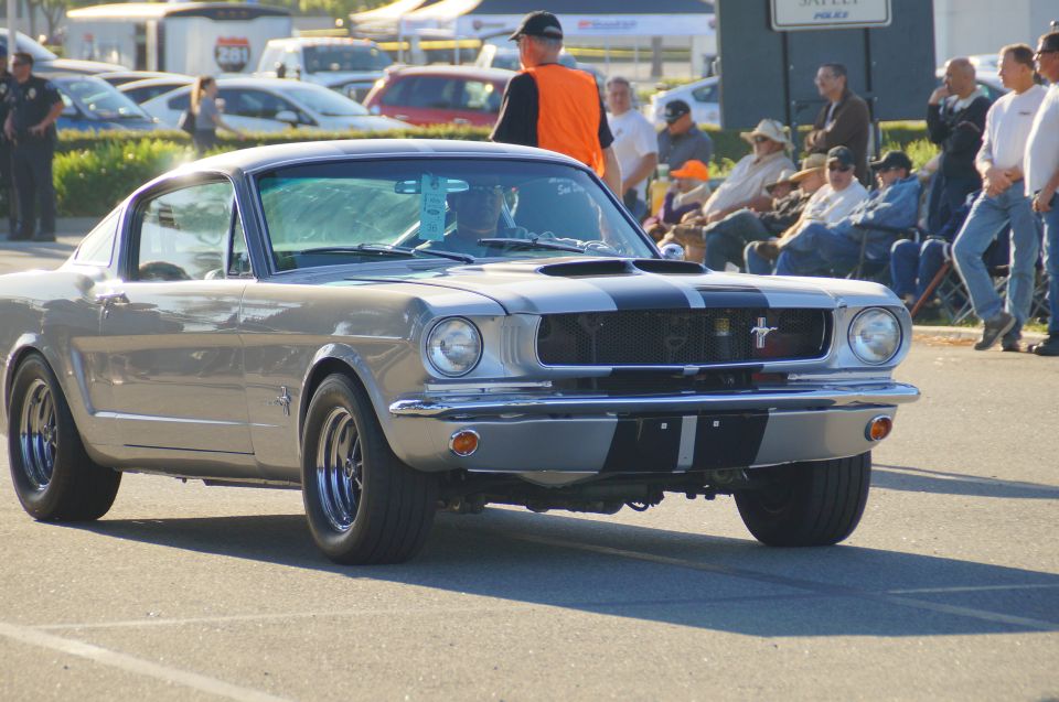 Silver 1960s Ford Mustang coupe with black racing stripes