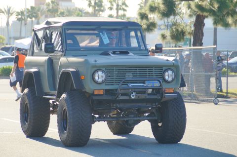 1993 Ford Taurus - This off-road vehicle is seen from the front, large tires and a dark green exterior.