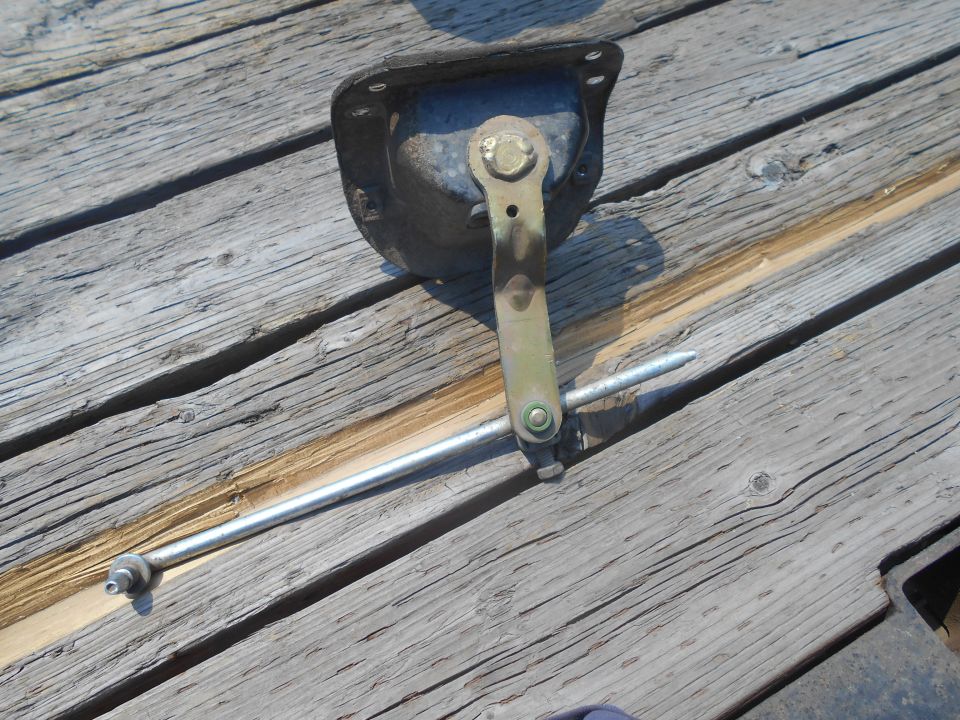 Vehicle linkage assembly on a wooden surface