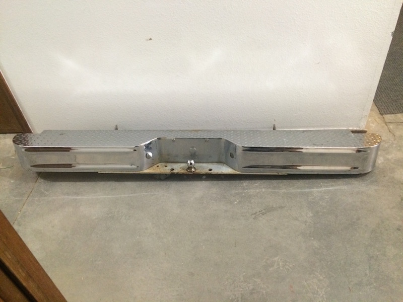 Chrome rear bumper with diamond plate step and trailer hitch receiver