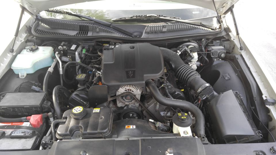 2004 Lincoln Town Car engine bay with V8 engine, battery, and fluid reservoirs.