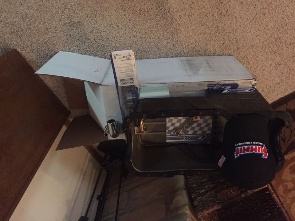 Black Summit Racing Equipment hat on a black oil pan, with a FEL-PRO box behind it.