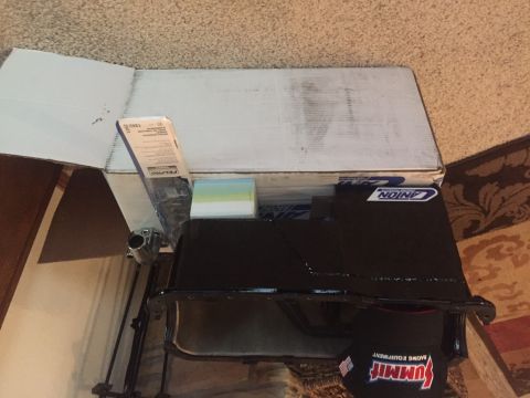 1982 Ford Bronco - A black Summit Racing Equipment oil pan sits inside an open cardboard box on a carpeted floor. A Fel-Pro gasket box is visible in the backg…