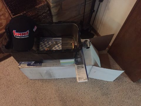 1982 Ford Bronco - A black Summit Racing Equipment hat sits inside a black oil pan. The oil pan is placed on top of a white box with Canton Racing Products br…