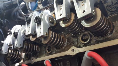 1978 Ford Bronco - Close-up view of the internal components of a V8 engine, likely a Ford small block, showing rocker arms, valve springs, and spark plug wire…