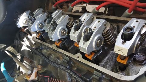1978 Ford Bronco - A close-up view of the rocker arms and valve springs on a V8 engine, likely from a 1978 Ford Bronco. The engine block is black, with silver…