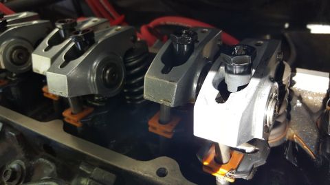 1978 Ford Bronco - A close-up view of several valve train components, likely from a V8 engine, showing rocker arms, valve springs, and pushrods. The component…