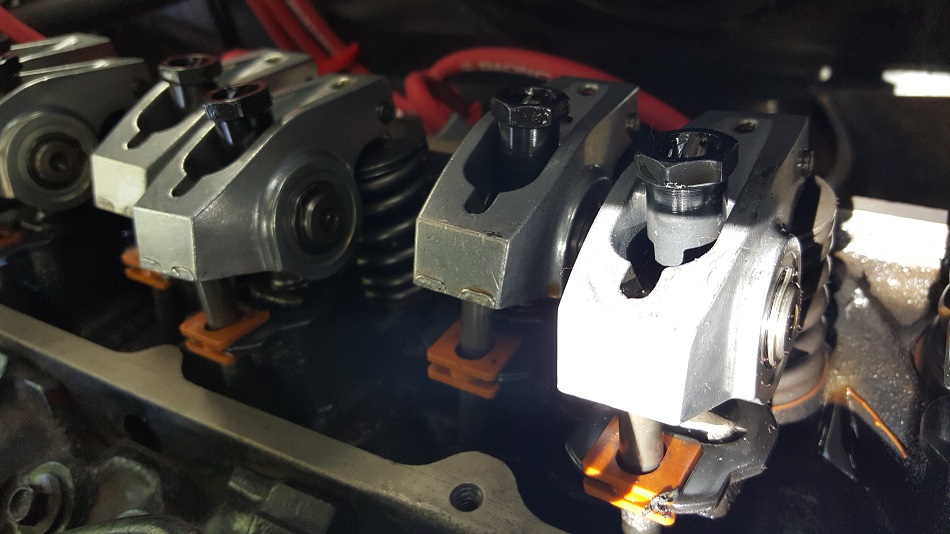 Close-up of engine valve train components: rocker arms, springs, pushrods.