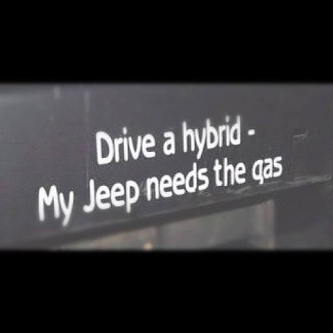 1985 Jeep CJ7 - A close-up shot shows white text on a dark surface that reads "Drive a hybrid - My Jeep needs the gas".