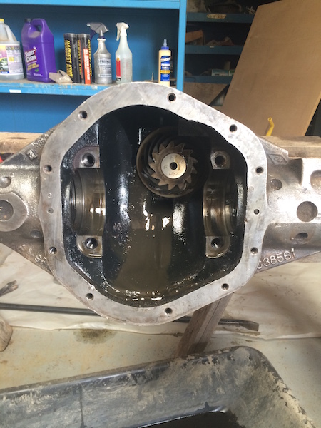 1981 Ford Bronco - This is a close-up view of an open differential housing, likely from a 1981 Ford Bronco, showing the internal gears and bearing caps. The h…