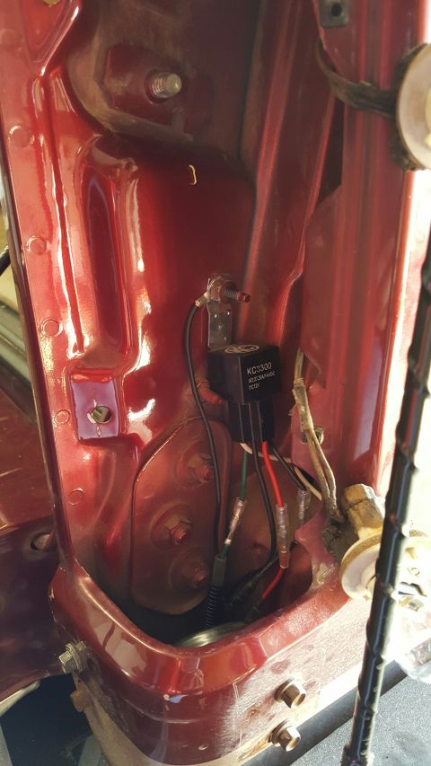 1996 Ford Bronco - A black KC3300 relay is mounted to the red painted interior of a vehicle, with multiple wires connected to it.