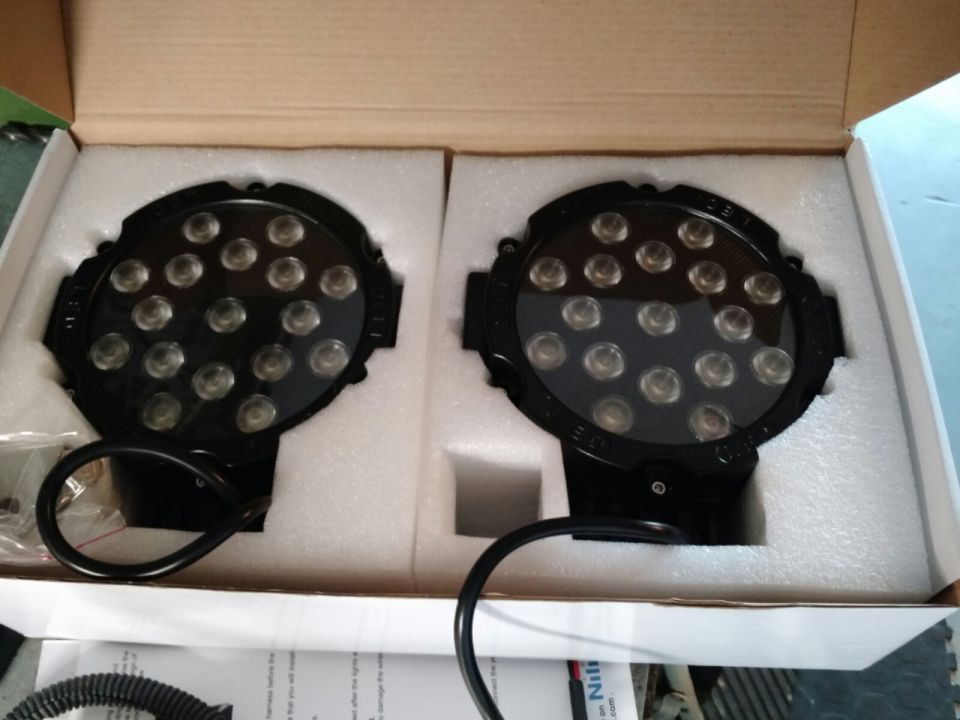 Two black LED light pods in packaging.