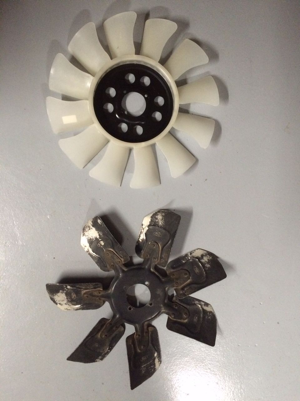 New white plastic fan and old black metal Ford fan