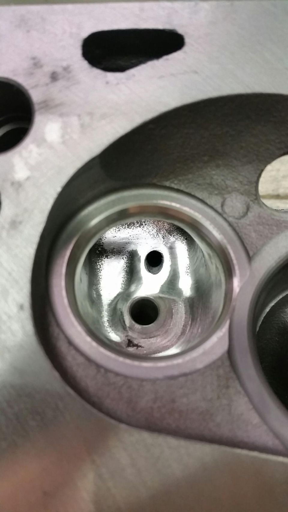 Close-up of a cylinder head combustion chamber with intake ports.