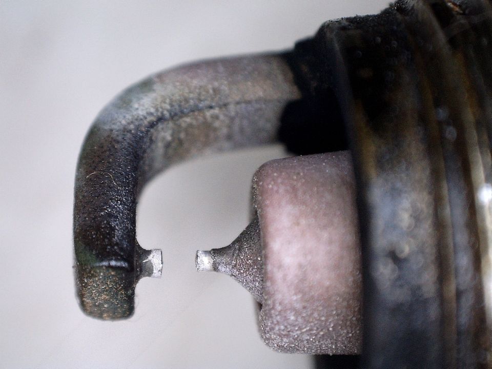 Close-up of a worn spark plug electrode gap