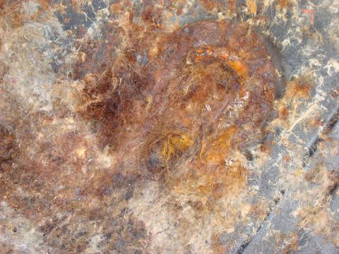 1981 Ford F-100 - This image shows heavily corroded metal parts, likely from the interior of a vehicle undergoing disassembly.