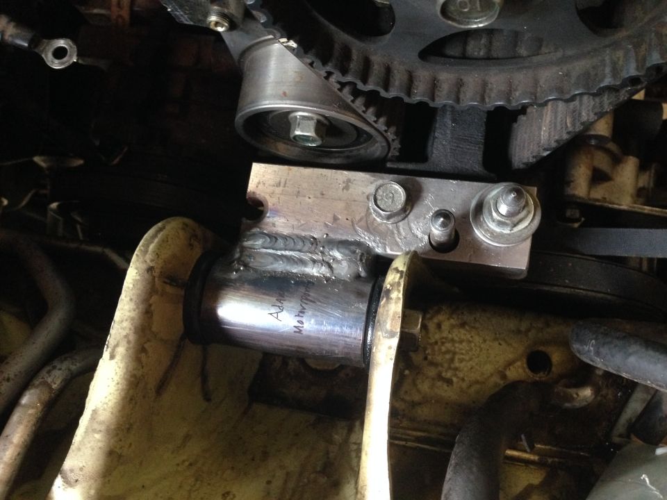 Custom engine part with welds and text 'Adam Motorsports'