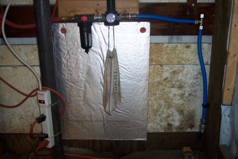 1990 Ford Bronco - This image shows a close-up view of plumbing and electrical components in what appears to be a basement or utility area. Visible items incl…