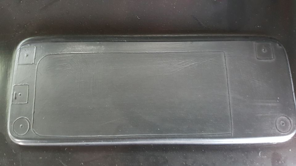 Black plastic automotive part with embossed details